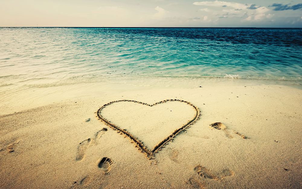 Heart drawn in sand on a beach